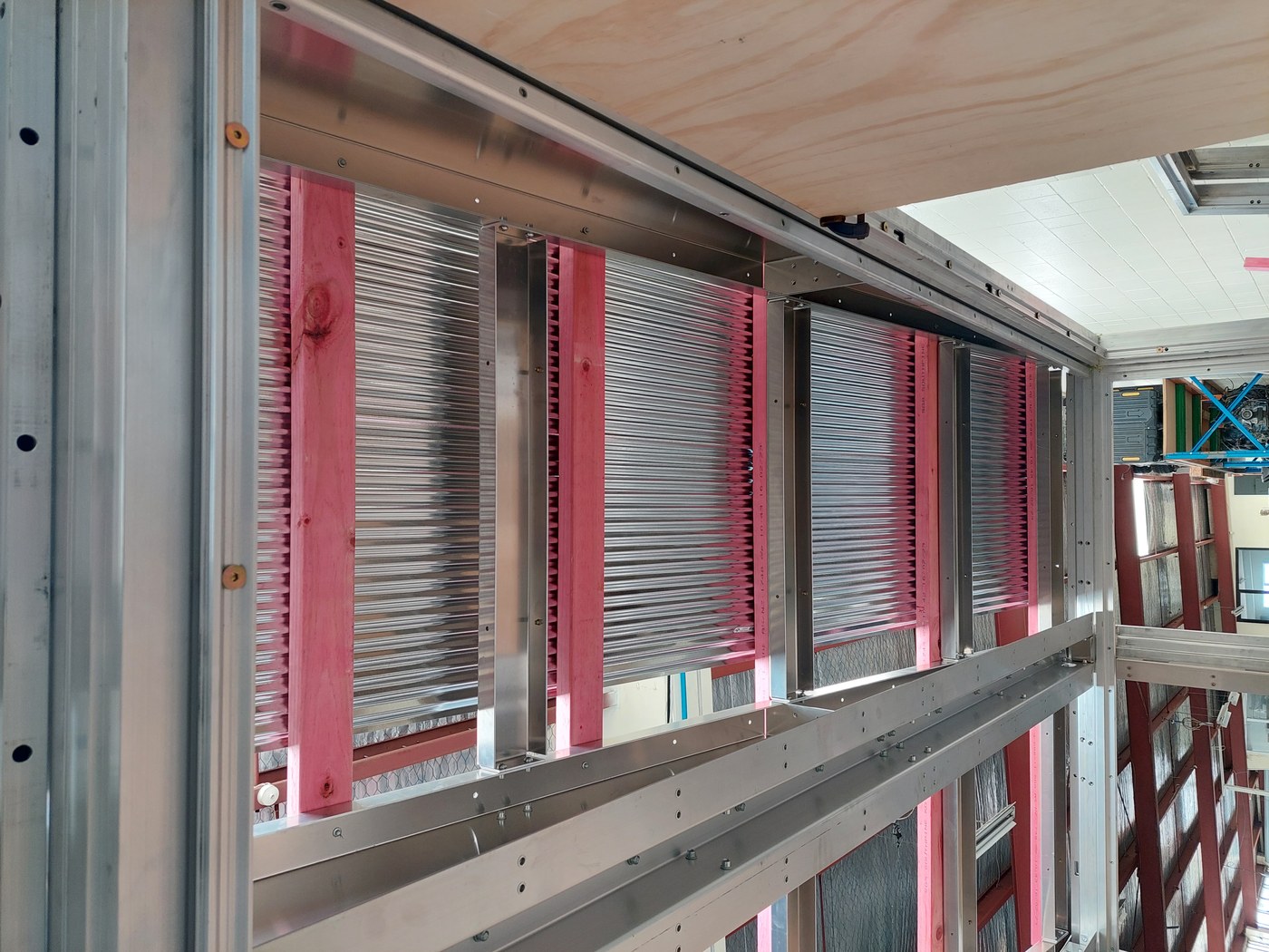 Anyplace roof showing aluminum purlins and timber nailer strips — hybrid construction