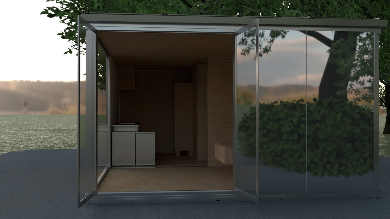 Anyplace module — open door, interior visible, garden setting at dusk